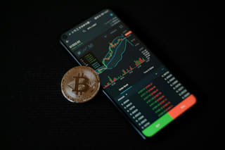 Test Scrap 4 trading app on a smartphone showing AI market analysis